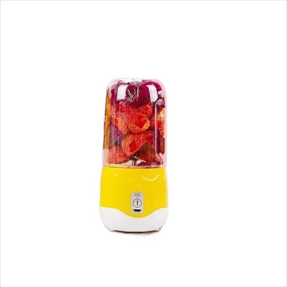 Yellow portable blender with red fruit inside on a white background