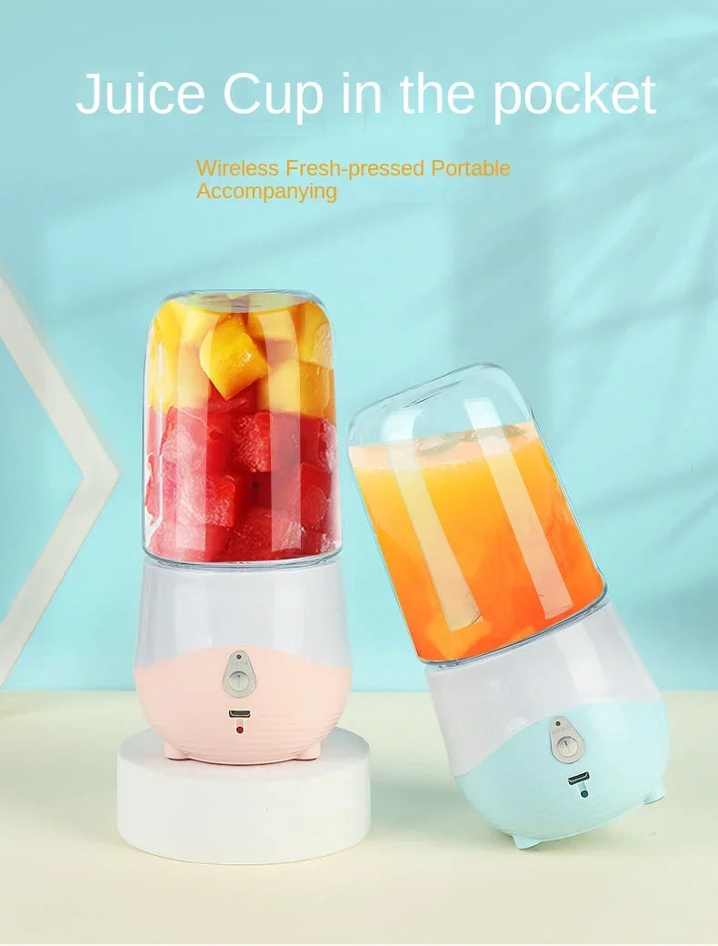 Portable blender with a juice cup filled with fruit and a glass of orange juice on a light blue background.