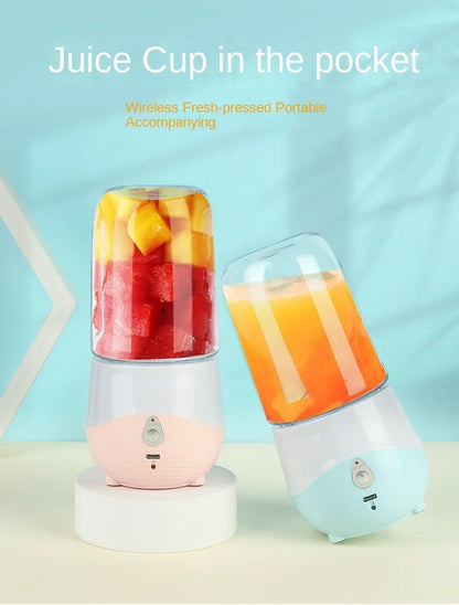 Portable blender with a juice cup filled with fruit and a glass of orange juice on a light blue background.