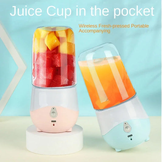 Portable blender with a glass container filled with juice on a light blue background