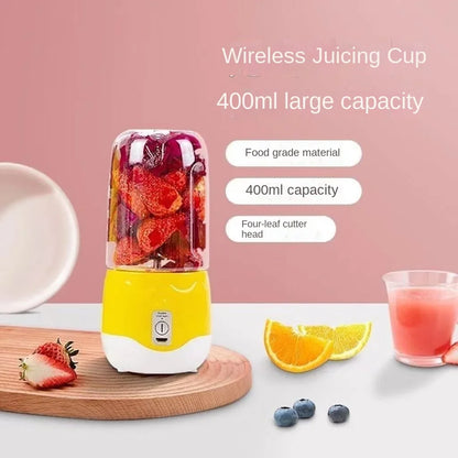Wireless juicing cup with fruits and a glass of juice on a pink background