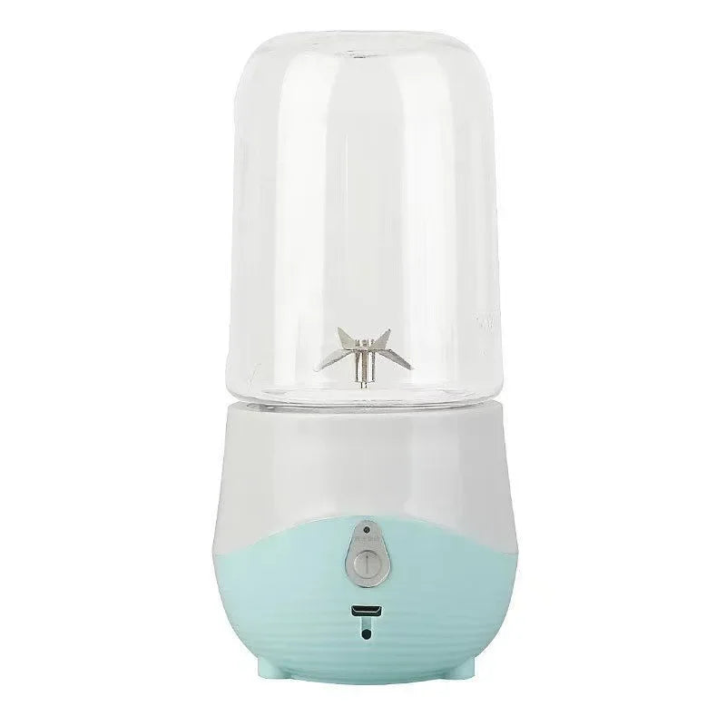 Portable blender with a light blue base and clear top on a white background